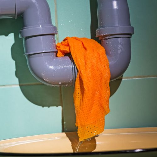 Pipe Leak With Towel Over It Bin Under It